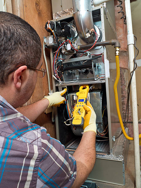 hispanic handyman repairman conducting residential hvac repair